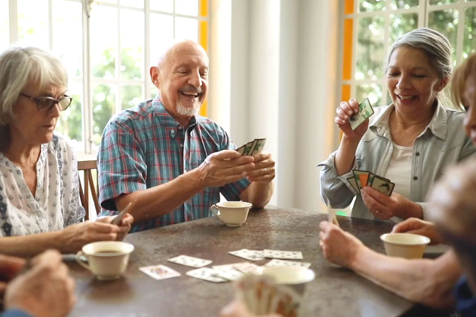 senior citizens playing cards